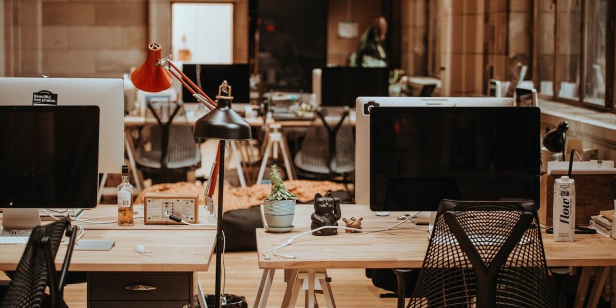 A cosy office space with wooden desks and expensive devices
